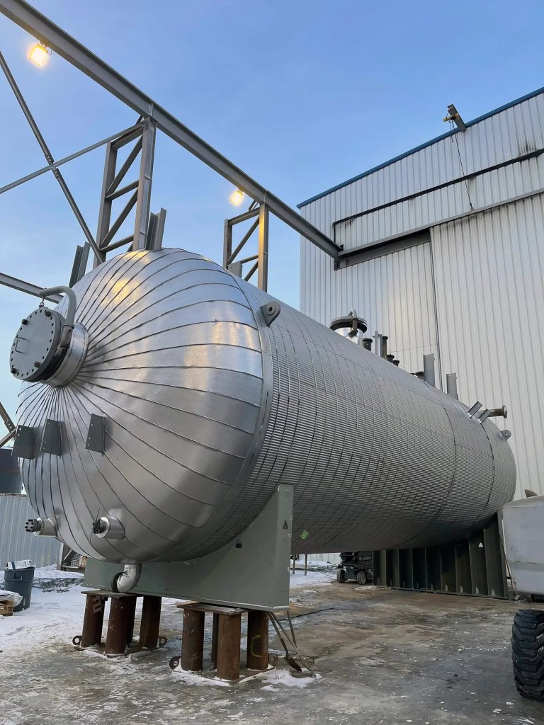 SCP crew installing insulation and cladding on a storage tank